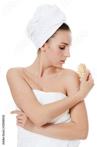 Photo: The beautiful woman with a massage brush. SPA concept. The beautiful woman with a massage brush. SPA concept.