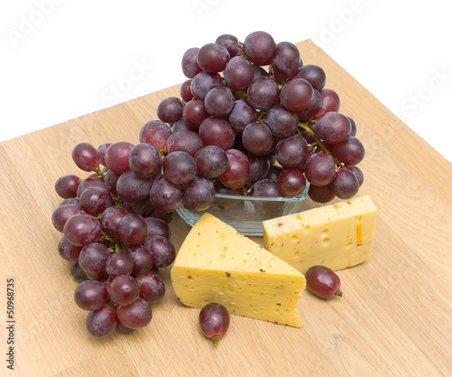 Photo: ripe grapes and cheese. Top view. ripe grapes and cheese. Top view.
