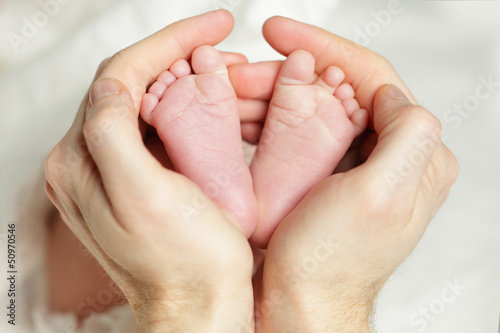 Photo: Newborn baby - feet in father hand Newborn baby - feet in father hand