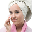A cute girl after a shower with cotton in the hands of