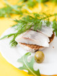 salted herring fillet on a piece of bread