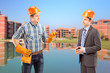 Male manual worker having a conversation with architect, constru