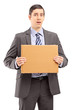 Upset young businessman in suit holding a piece of cardboard