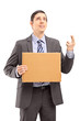 Businessman in suit with fingers crossed holdin