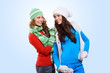 Photo: Two girls in winter hats and scarfs Two girls in winter hats and scarfs