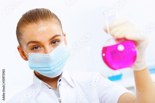 Photo: Young female scientist working in laboratory Young female scientist working in laboratory