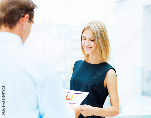 Photo: Two young business collegues. Two young business collegues.