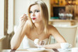 A woman in the restaurant is eating ice cream