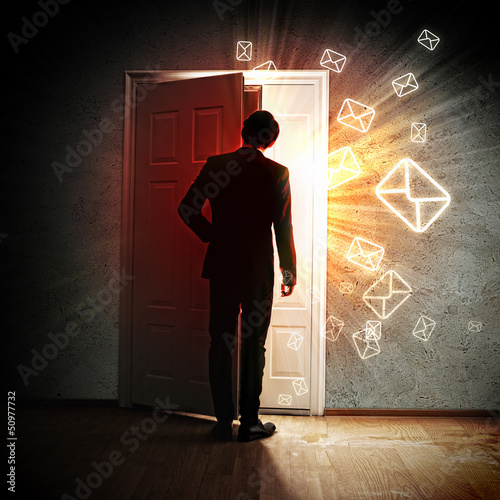 Photo: Young businessman opening door Young businessman opening door