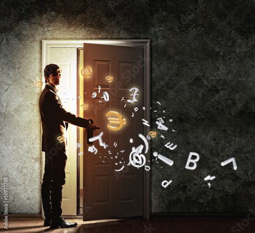 Photo: Young businessman opening door Young businessman opening door