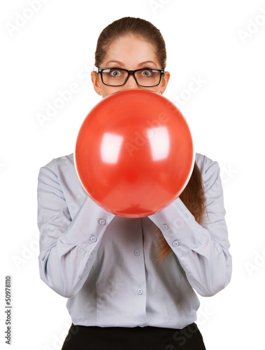 Photo: Girl inflating a large red balloon Girl inflating a large red balloon