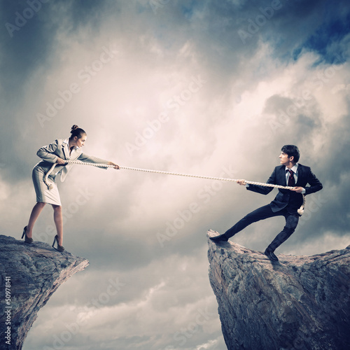 Photo: People pull the rope. People pull the rope.