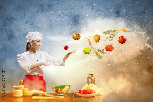 Photo: Asian female cooking with magic Asian female cooking with magic