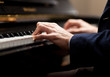 Hands playing the piano
