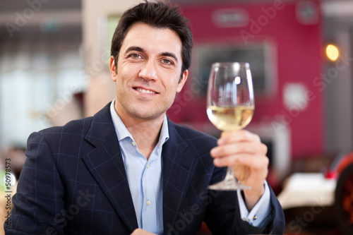 Photo: Man toasting wine in a restaurant Man toasting wine in a restaurant