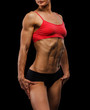 Muscular strong woman on a black background