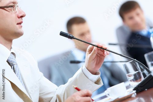 Photo: Three businesspeople at meeting Three businesspeople at meeting