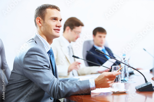 Photo: Three businesspeople at meeting Three businesspeople at meeting