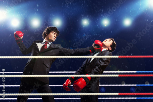 Photo: Two young businessman boxing Two young businessman boxing
