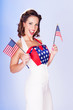 Cute brunette celebrating 4th July with American flags