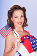 Photo: Cute brunette celebrating 4th July with American flags Cute brunette celebrating 4th July with American flags