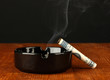 smoking cigarette of the 100 dollar bill and an ashtray