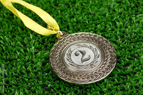 Photo: Silver medal on grass background Silver medal on grass background