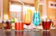 Several glasses of different drinks on bright background