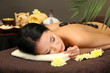 Beautiful young woman in spa salon with spa stones,