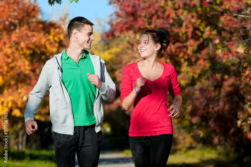 Photo: Young man and woman running Young man and woman running