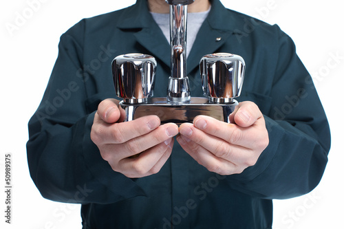 Photo: Hands of plumber with faucet. Hands of plumber with faucet.
