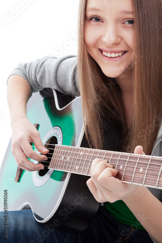 Photo: .Beautiful girl with guitar on white background .Beautiful girl with guitar on white background