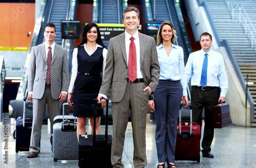 Photo: Group of business people in airport. Group of business people in airport.