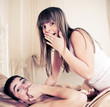 Surprised sex couple lying in bed