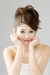 Beautiful young woman isolated on gray