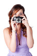 Surprised woman taking picture with old camera