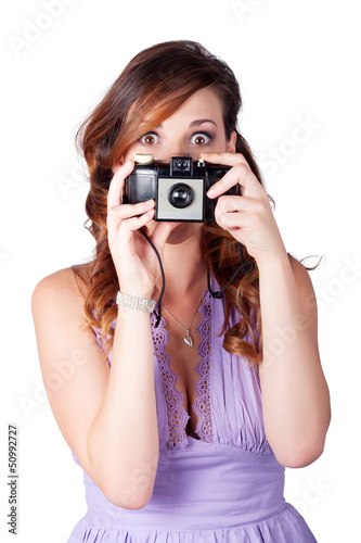 Photo: Surprised woman taking picture with old camera Surprised woman taking picture with old camera