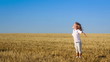 Happy child enjoying the sun in summer field. Slow motion