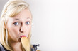 Beautiful female cook tasting food on wooden spoon