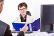 Photo: Business woman with folder speaks to man in a suit Business woman with folder speaks to man in a suit