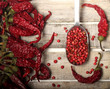 Dry pepper and grains on wooden background