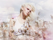 Blossom. Blonde in Windy Field with Flowers. Nature. Springtime