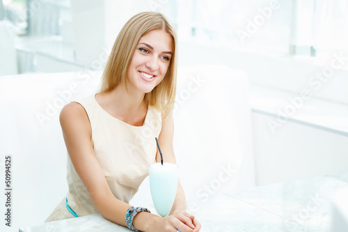 Photo: Young woman with a glass of drink Young woman with a glass of drink