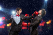 Two young businessman boxing