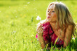 girl blowing on a dandelion