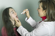 Pediatric doctor examining  girl's throat