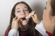 Pediatric doctor examining  girl's throat