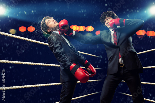 Photo: Two young businessman boxing Two young businessman boxing