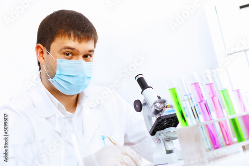 Photo: Young male scientist working in laboratory Young male scientist working in laboratory