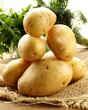 fresh organic potatoes on a wooden table